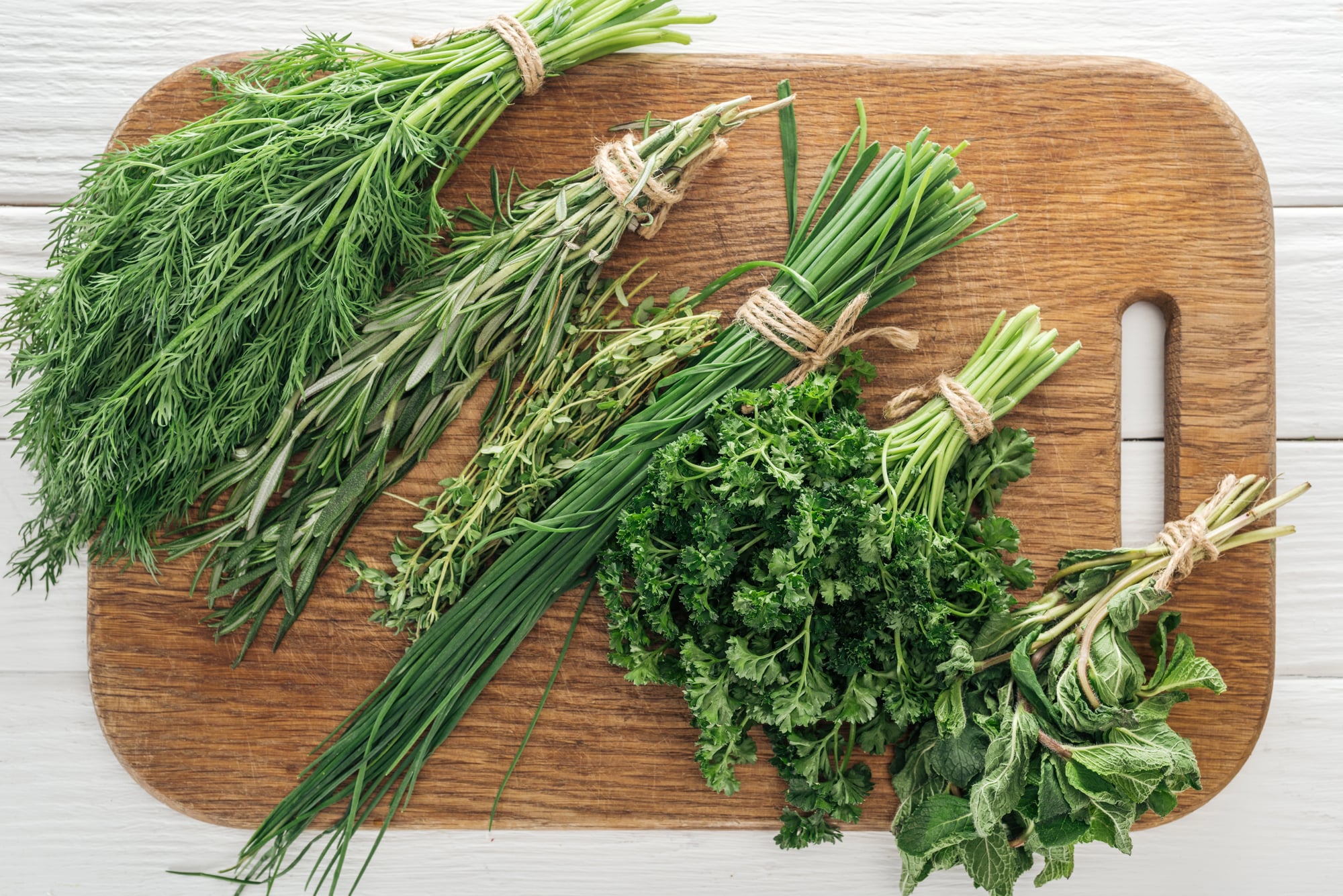 fresh herbs on a cutting board