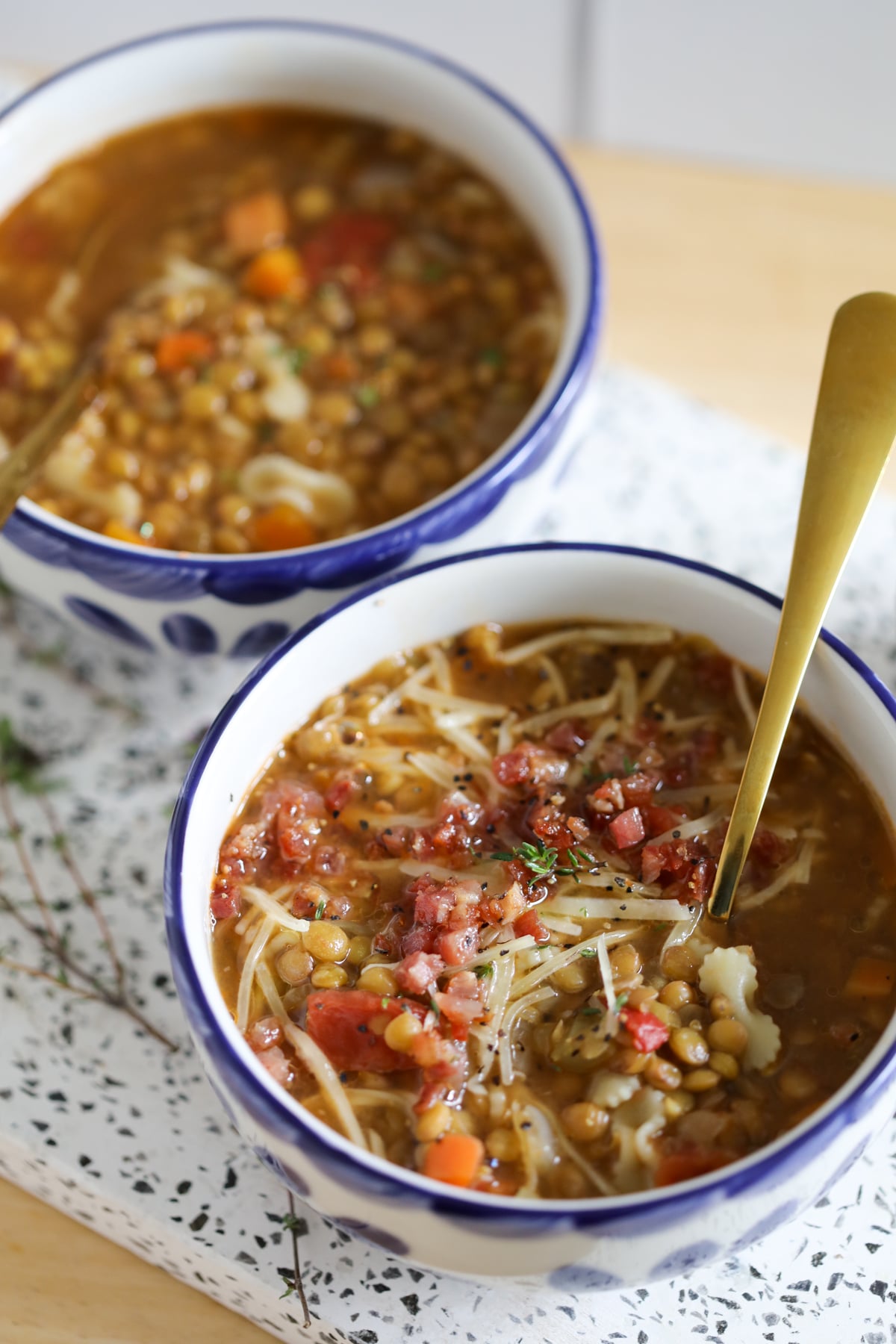 Two bowls of lentil soup being served for a high protein meal.
