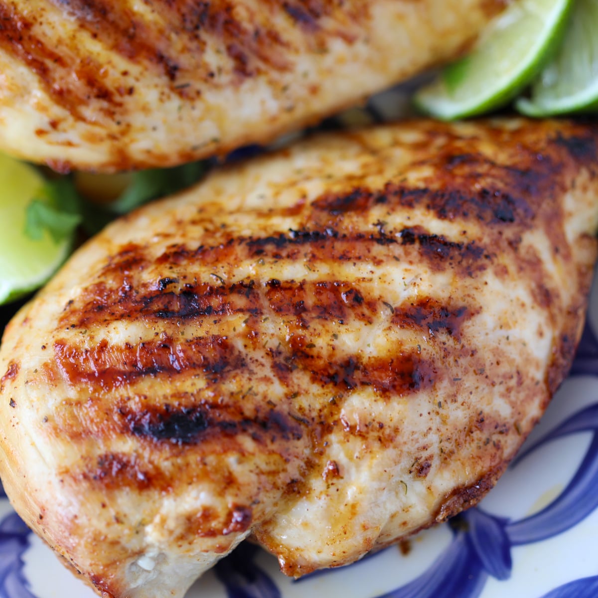 close up of ninja foodi grill chicken breasts on a blue and white plate